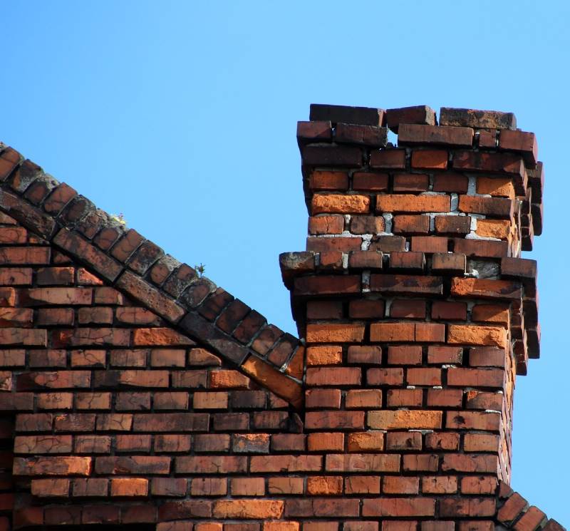 Damaged chimney on an Baltimore home showing cracks and missing mortar